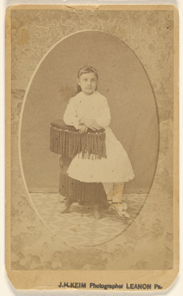 J.H. Keim:[Unidentified little girl posed on chair with tass, Poster Print Wall Art
