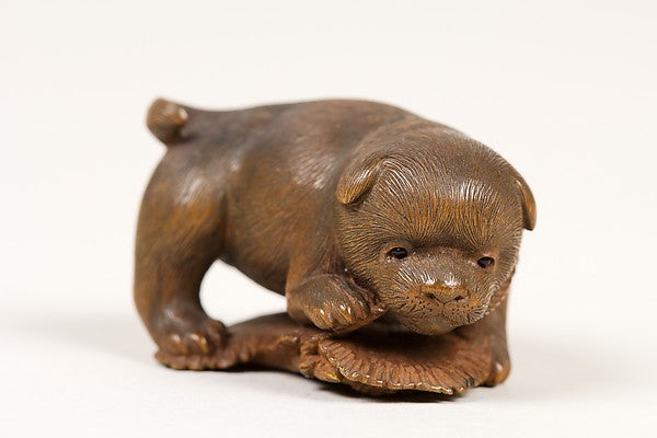 Netsuke of Puppy on Straw Mat Biting String, Poster Print