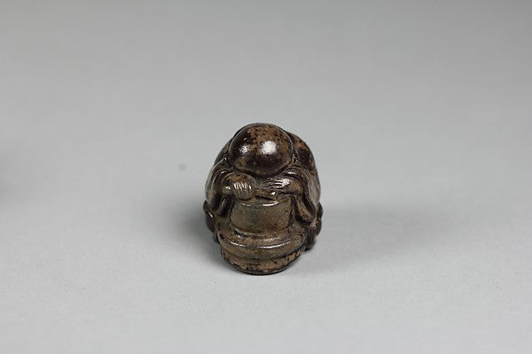 Netsuke of of a Priestling Asleep over a Stonemill 18th cent, Poster Print