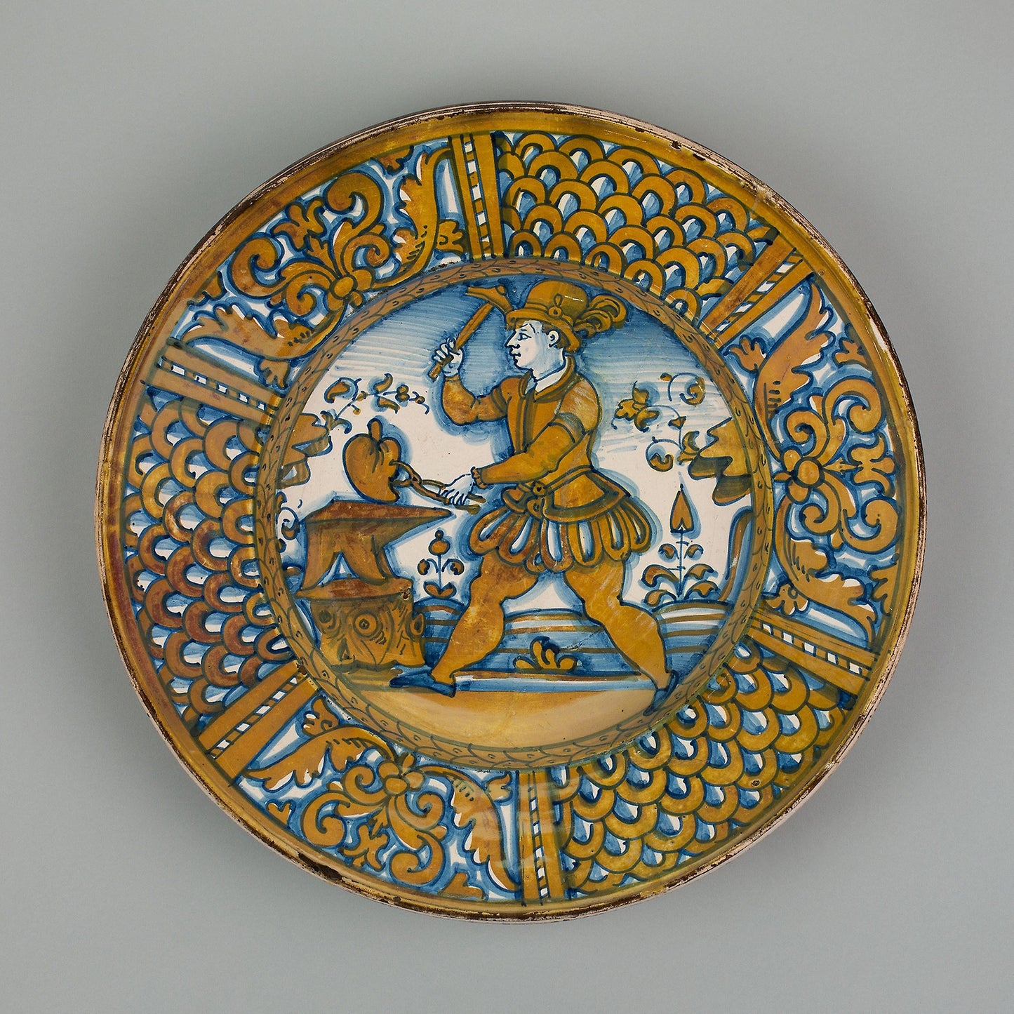 Display Plate with a Man Striking a Heart on an Anvil: Italian; Deruta, Poster Print Wall Art