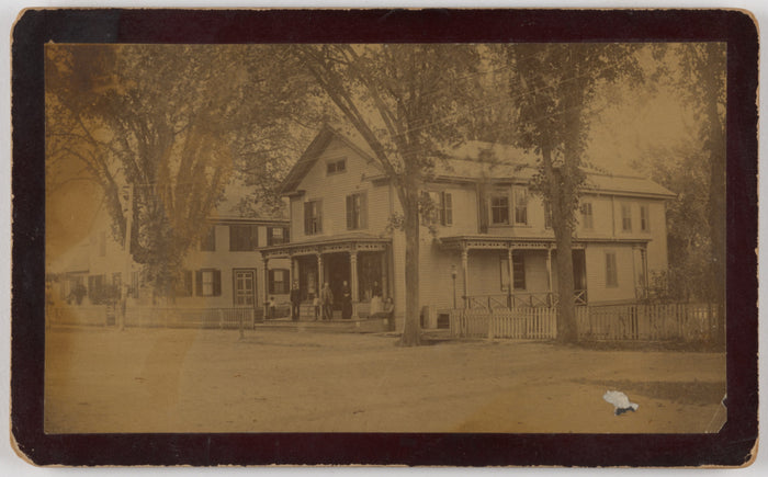 Know:[Long view of house with family on front porch],16x12