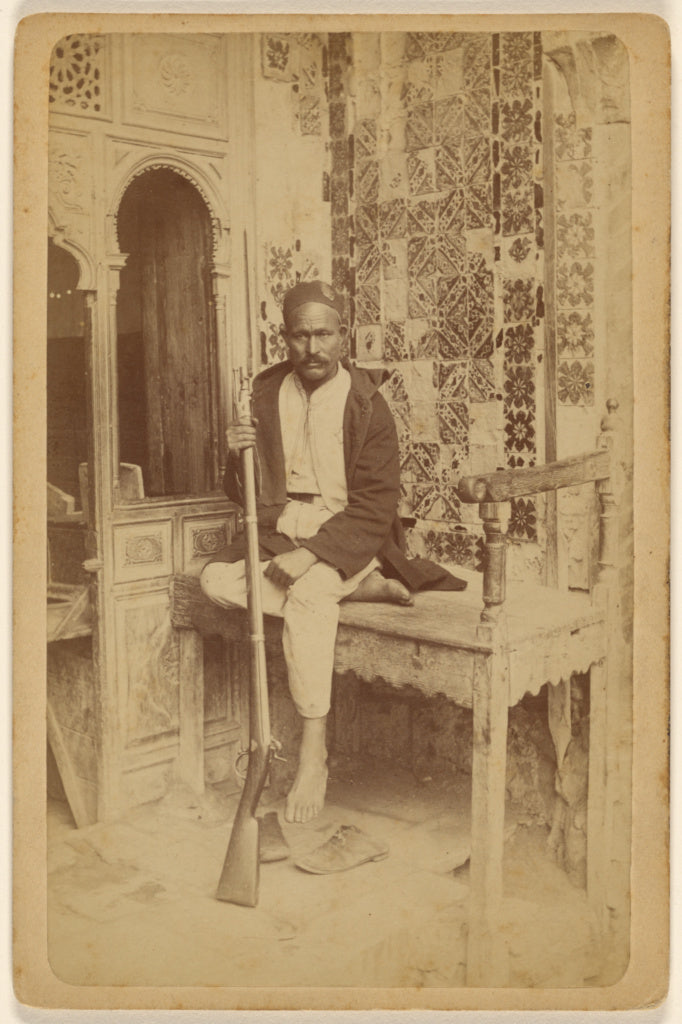 Unknown:[Arab male seated, holding a rifle, with shoes off], Poster Print Wall Art