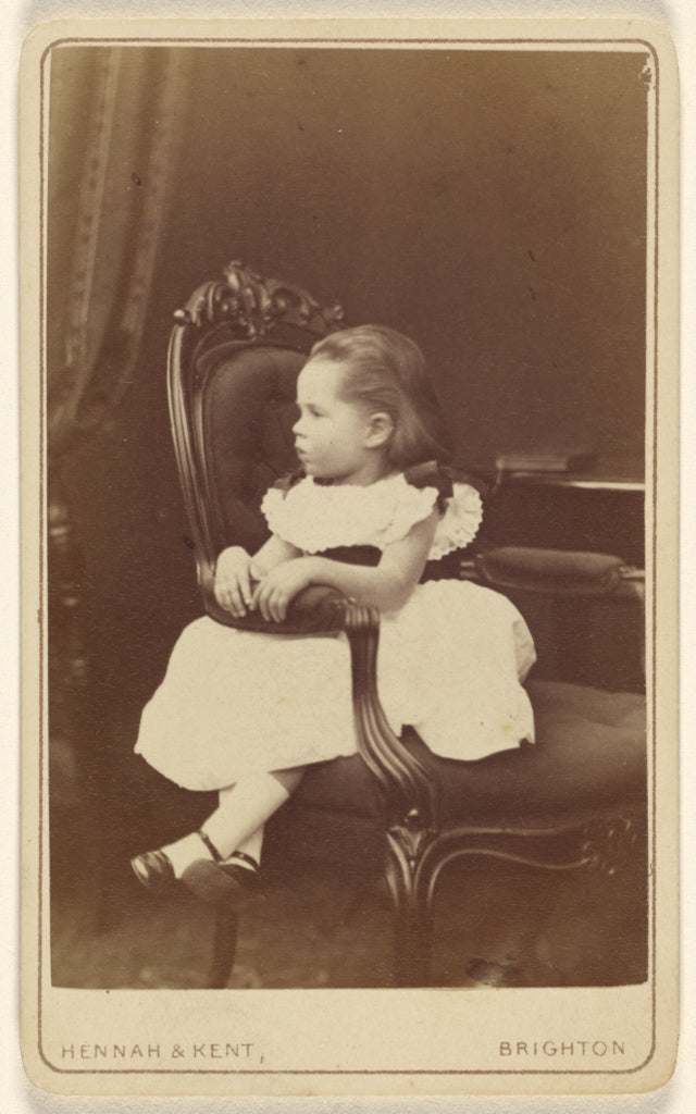 Hennah & Kent:[Little girl seated sideways in an armchair], Poster Print Wall Art