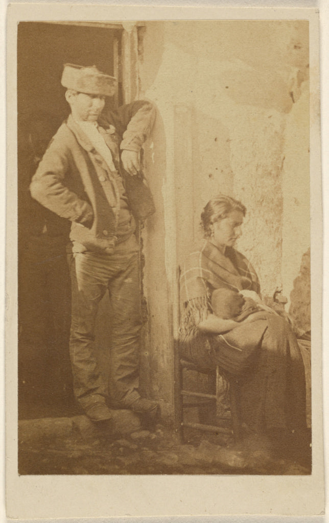 Unknown:[Man standing next to a seated woman holding a baby],16x12