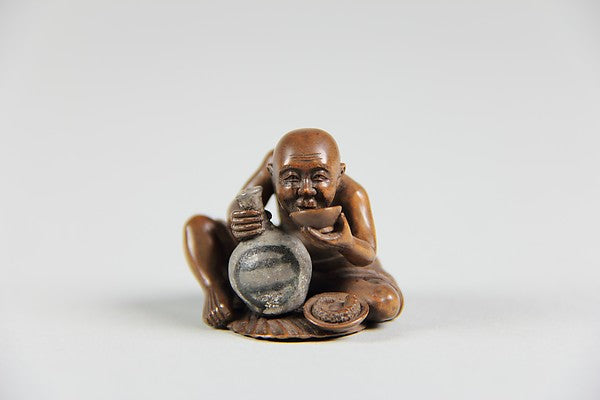 Netsuke of a Man Holding a Small Bottle in One Hand and Drinki,  Poster Print
