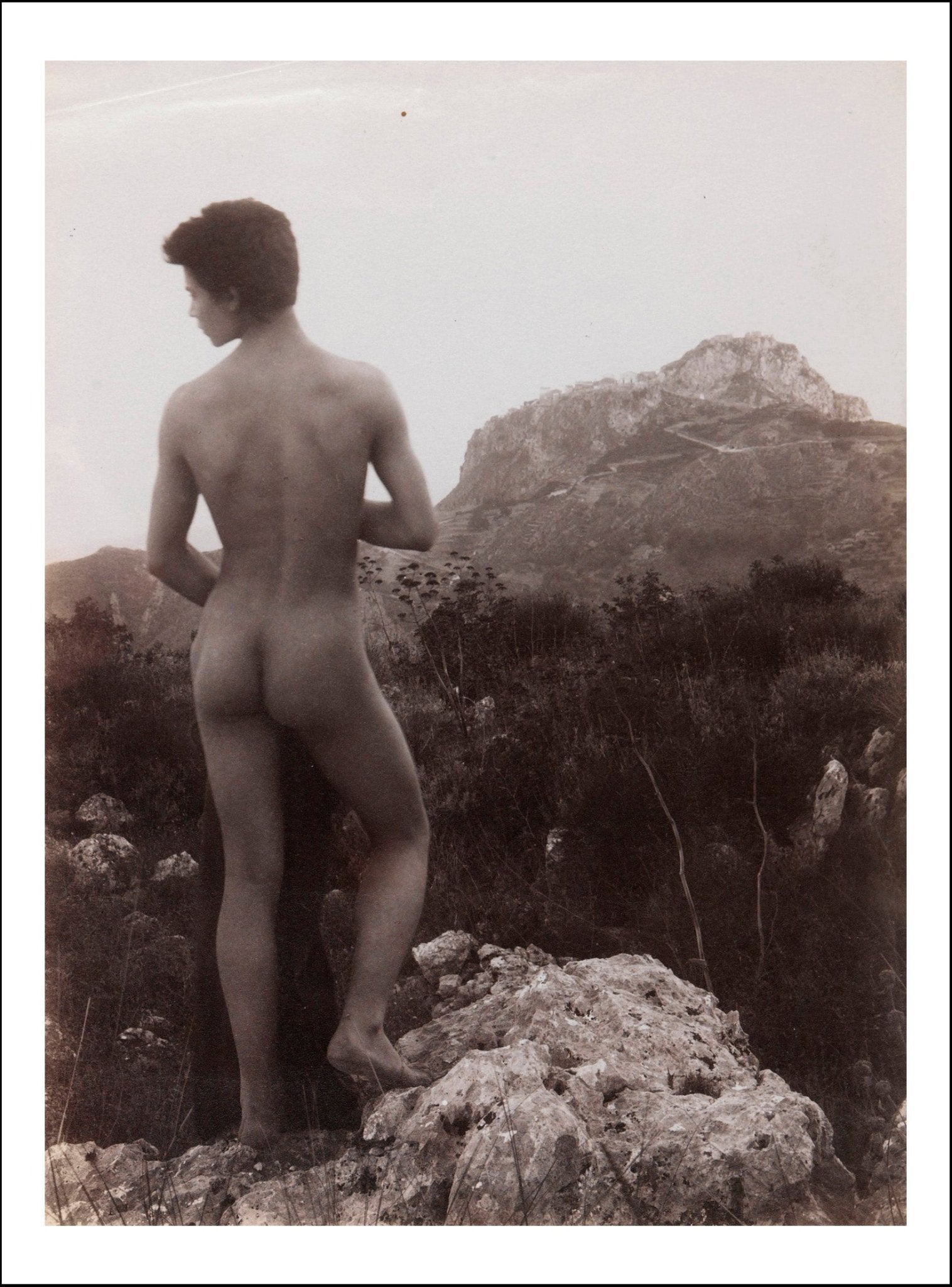 A naked Sicilian in a rocky setting outdoors by Wilhelm von Gloeden, histoic photo, 12x8" (a4) Poster Print